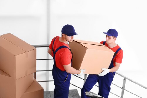 Removal team member loading furniture safely with protective padding