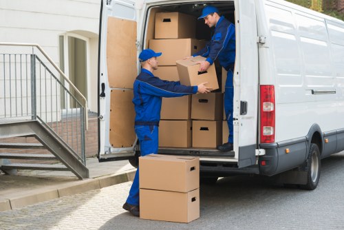 Removal staff working carefully with packed items during loading