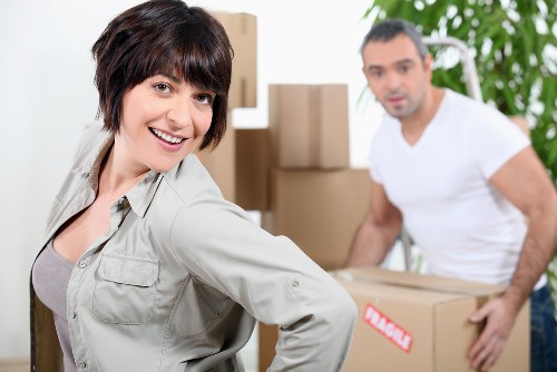 Removal workers handling furniture in a Fulham property