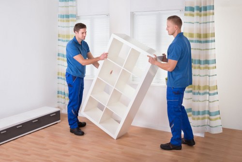 Movers preparing household furniture for removal in Fulham