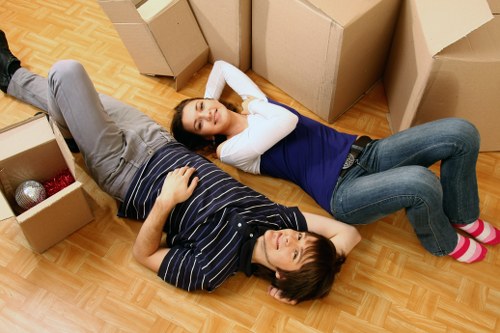 Packed moving boxes and furniture ready for transport in a Fulham home