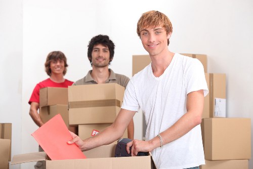 Local movers delivering and placing furniture in a Fulham property