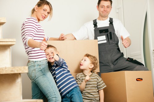 Professional movers packing boxes into a van in Fulham